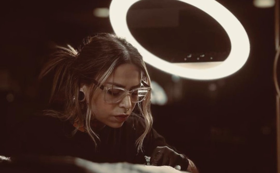 Cinematic close-up of a professional tattoo artist